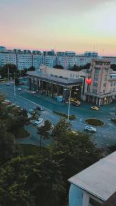 a city street with a red traffic light and buildings at Gara De Nord 3 Rooms Apartment Superb City View in Bucharest