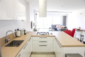 A kitchen or kitchenette at Gorgeous 2BR Gozo Apt with private balcony & Pool by 360 Estates