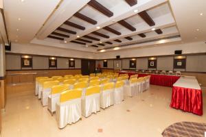 a banquet hall with yellow and white tables and chairs at Hotel Luciya Palace in Trichūr