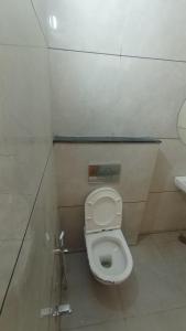 a bathroom with a white toilet and a sink at Hotel kingdom in Indore