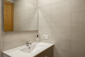 a bathroom with a sink and a mirror at 2 Jardin 1 - Toró in Llanes +18 photos