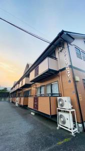 a building with a lot of windows on a street at apartment hotel myu didymi in Utsunomiya