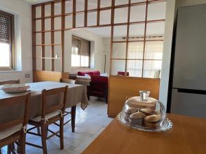 a living room with a table and a dining room at Terrazza Idrusa in Otranto