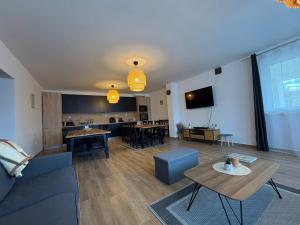 a living room with a couch and a table at Hudák Vendégház in Abod