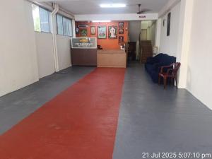 a hallway with a red carpet in a room at Pvt Residency in Palni