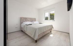 a white bedroom with a bed and a window at 2 Bedroom Gorgeous Apartment In Vir in Vir