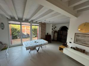 a living room with a table and a large window at Le Vele Del Cigno in Peschiera del Garda