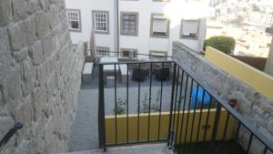 a balcony with a fence and a building at SBV Perfect River View in Porto