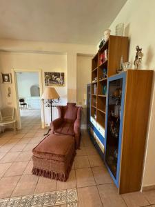 a living room with a chair and a book shelf at Baccano Escape in Rome
