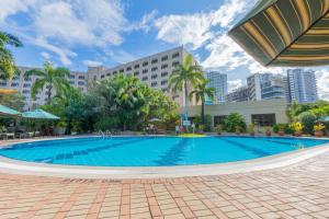a large swimming pool in the middle of a city at Dar es Salaam Serena Hotel in Dar es Salaam