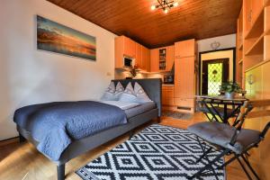 a bedroom with a bed and a table in a room at Winzig Apartment in Schladming