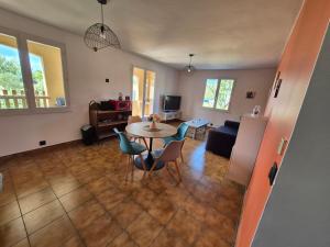 a living room with a table and chairs at La Verdière in Barjols