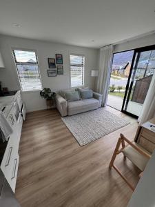 a living room with a couch and a table at One bedroom apartment in Queenstown Airport
