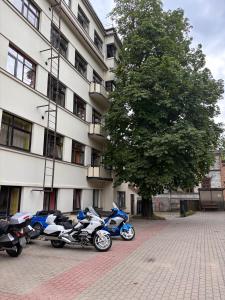 a row of motorcycles parked in front of a building at Bridge Hotel in Rīga