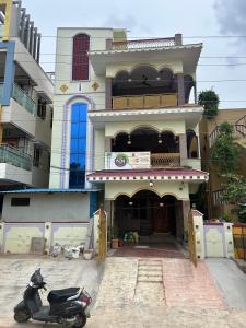 a scooter parked in front of a building at Nature's Nest Homestay Tirupati close to Sri Padmavathi Ammavari Temple Tiruchanur close to toll road connecting all highways just behind Taj Tirupati and easy access to Garuda fly-over to Tirumala in Tirupati