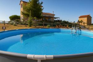 una gran piscina con un tobogán frente a una casa en EuZoea Country Home, en Kapandrítion 40 fotos más