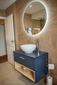 a bathroom with a sink and a mirror at The Old Ginn House Inn in Great Clifton +65 photos
