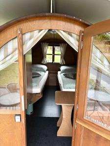 an open door of an rv with two bunk beds at Schlaffässer Ferienhaus Berger in Bad Karlshafen +17 photos