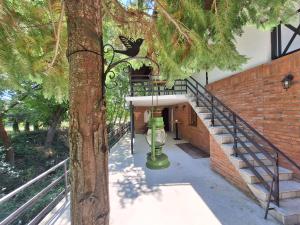 a green fire hydrant sitting next to a staircase at Villa Srna Apartments in Brazda
