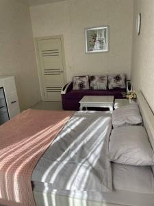 a bedroom with a large bed with two pillows at Апартаменти в АРКАДІЇ 10 хв до моря in Odesa
