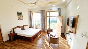 a bedroom with a bed and a large window at Ranthambore Jalsa in Sawāi Mādhopur