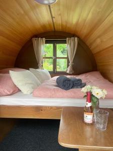 a bed in a small room with a window at Schlaffässer Ferienhaus Berger in Bad Karlshafen