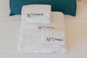 two white towels with the words wet pucka on them at Wanderlust Experience Villa Milly in Giovinazzo +45 photos