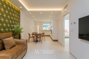a living room with a couch and a table at Wanderlust Experience Villa Milly in Giovinazzo