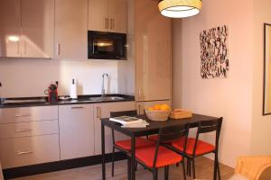 a kitchen with a table with two chairs and a sink at Panther Home Salvador in Seville