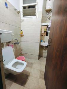 a bathroom with a toilet and a sink at Fully Private 1BHK Couple Friendly at Serene Green Entire rental unit in Indore, India in Indore