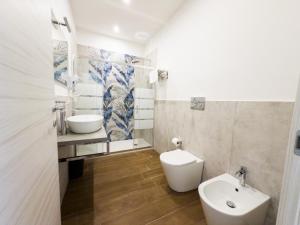 a bathroom with a toilet and a sink at Carlo's House in Bosa +30 photos