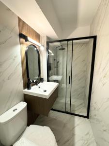 a bathroom with a toilet and a sink and a shower at Cismigiu Bucharest Central 2 bedrooms Apartment in Bucharest