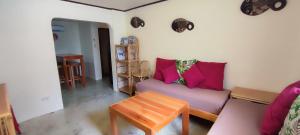 a living room with a couch and a table at Picado House in El Nido