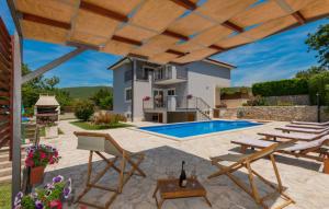 a patio with a swimming pool and a house at Villa Ruza - Omis by Villas Guide in Blato na Cetini