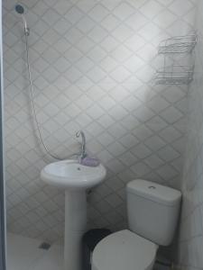 a white bathroom with a toilet and a sink at Bagrationi 54 in K'obulet'i +71 photos