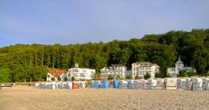 a group of chairs on a beach with houses at Villa Strandperle, App 04 - nur 20m zum Strand, TOPLAGE in Binz