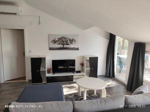 a living room with a couch and a table at Apartmani Bezek in Ston