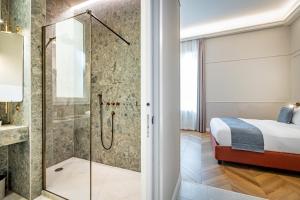 a bathroom with a shower and a bed at Dimora Collection - Le Logge - Historic Boutique Luxury Suites in Florence