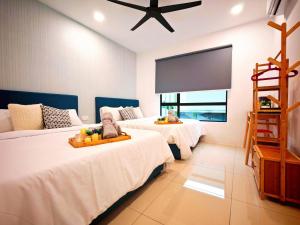 a bedroom with two beds and a flat screen tv at Ipoh Manhattan Free Waterpark 3BR 8Pax Family Suite MHA308 by City Home Empire in Ipoh +48 photos