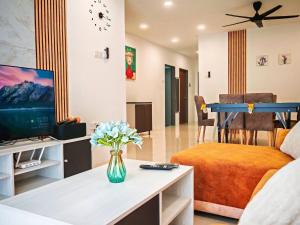 a living room with a couch and a tv at Ipoh Manhattan Free Waterpark 3BR 8Pax Family Suite MHA306 by City Home Empire in Ipoh