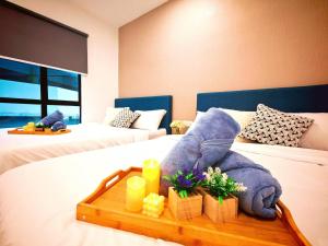 a hotel room with a tray of food on a bed at Ipoh Manhattan Free Waterpark 3BR 8Pax Family Suite MHA306 by City Home Empire in Ipoh +57 photos