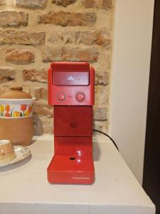 a red sewing machine sitting on top of a counter at Don Ciccio GH in Bova Marina