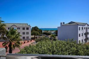 a view of a city with buildings and trees at 61 Big Bay Beach Club in Cape Town