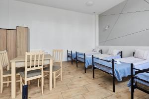 a room with several beds and a table and chairs at Viola in Police +27 photos