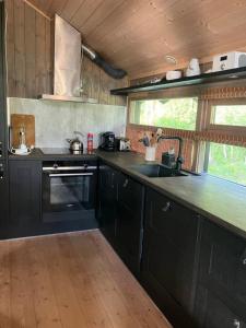 a kitchen with black cabinets and a counter top at Ski in ski out in Geilo, comfortable and family friendly cabin in Geilo