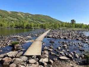 a bridge over a river with rocks at Ski in ski out in Geilo, comfortable and family friendly cabin in Geilo