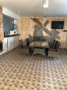 a living room with a table and a couch at Номер з кондиціонером in Chernihiv +19 photos