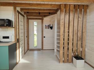 a kitchen with wooden walls and a staircase in a house at KBarn in Krasnik +6 photos