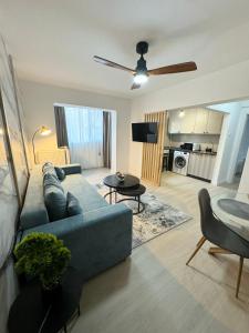 a living room with a blue couch and a table at Cismigiu Bucharest Central 2 bedrooms Apartment in Bucharest