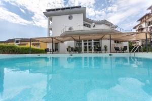 a large swimming pool in front of a building at Hotel Sea Sand in Sveti Vlas +48 photos